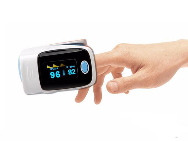 A person using an oxygen monitoring tool with their fingertip.